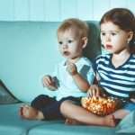 children-brother-and-sister-watching-tv-in-evening-picture-id683821088