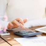 businesswoman-using-calculator-picture-id622046306