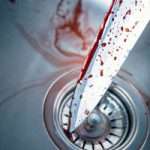Bloody knife in kitchen sink for Halloween or crime