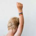 raised-child-hand-with-rainbow-lgbtq-pride-flag-tattoo-picture-id1253860590